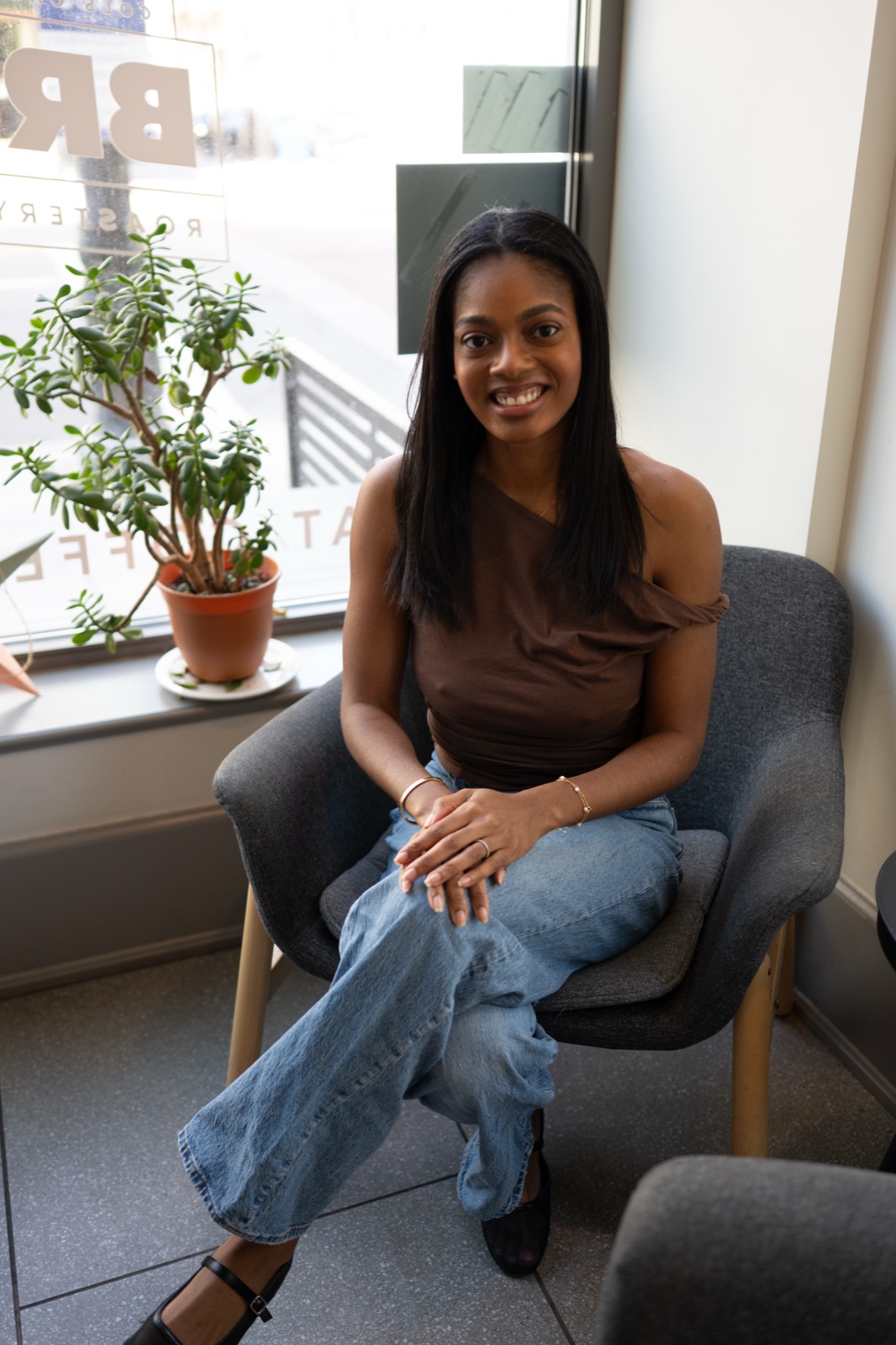 Rukiya Ross smiling, seated by a window